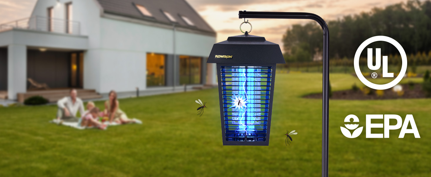 Bug zapper with bright blue light in large backyard with a family sitting on a blanket