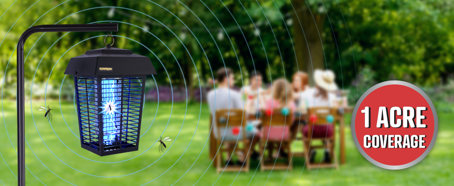 Friends eating at table outside with bug zapper in the distance 